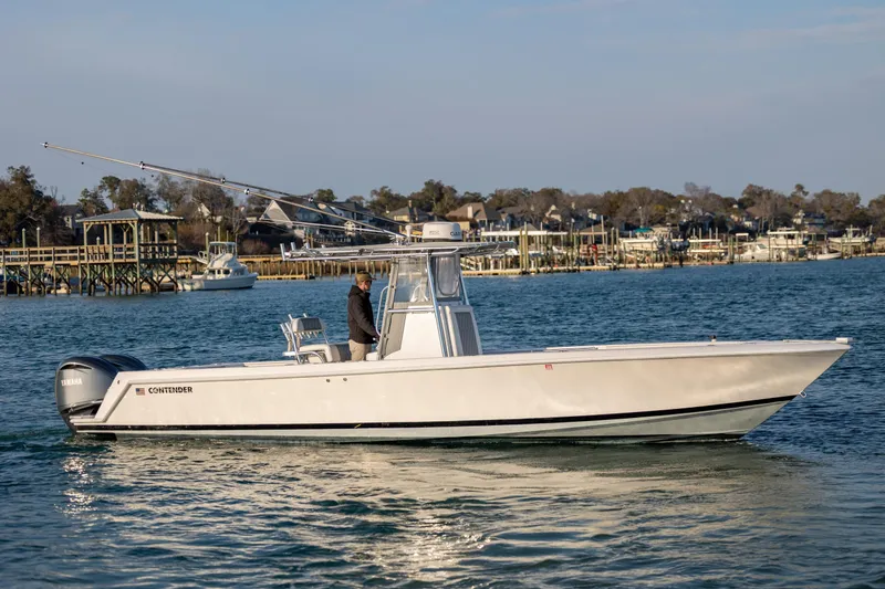 Slide: The Image of 2013 Contender 32 Tournament boat cruising on a calm waterway. - 8
