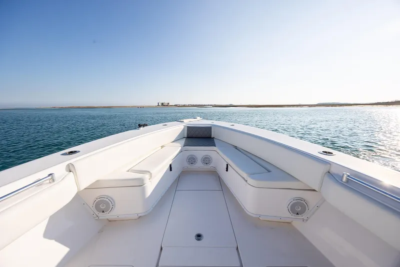 Slide: The Image of 2013 Contender 32 Tournament boat on calm water, featuring spacious seating and clear blue sky. - 9