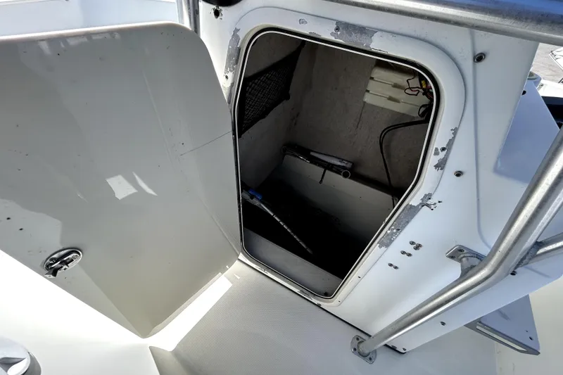 Slide: The Image of 2004 Hydra-Sports Lightning 230 CC boat interior with rod holders and storage compartments. - 16