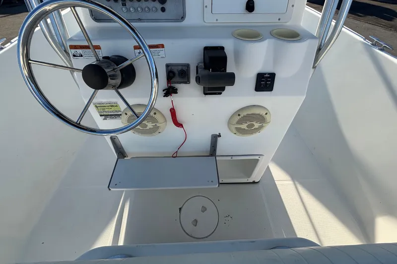 Slide: The Image of 2004 Hydra-Sports Lightning 230 CC boat console with steering wheel and controls. - 24