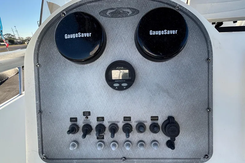 Slide: The Image of 2004 Hydra-Sports Lightning 230 CC dashboard with gauges and control switches. - 25