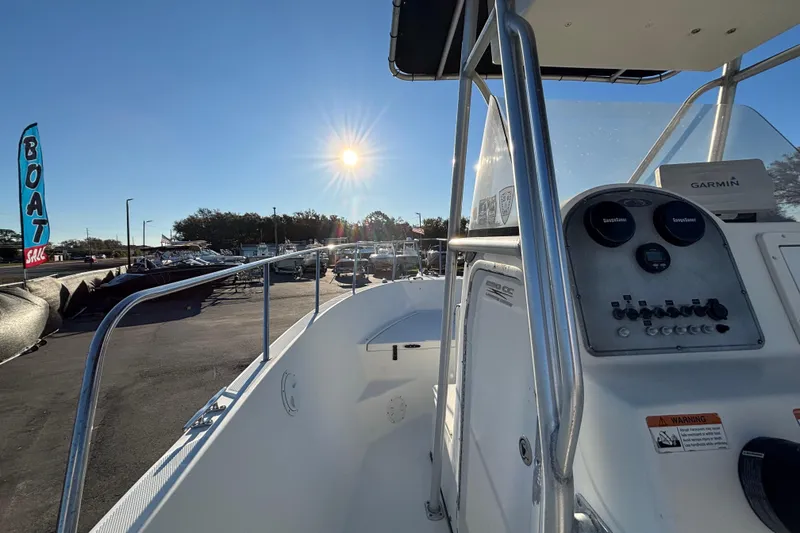 Slide: The Image of 2004 Hydra-Sports Lightning 230 CC boat dashboard under bright sun at a sales lot. - 30