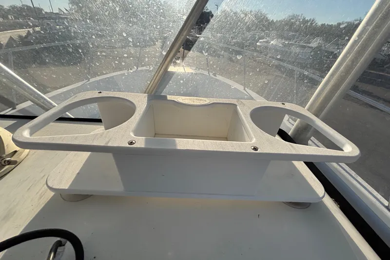Slide: The Image of 2004 Hydra-Sports Lightning 230 CC boat console with cup holders and storage compartment. - 33