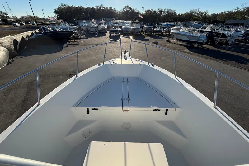 Slide: The Image of 2004 Hydra-Sports Lightning 230 CC boat docked, showcasing spacious deck and sleek design. - 34