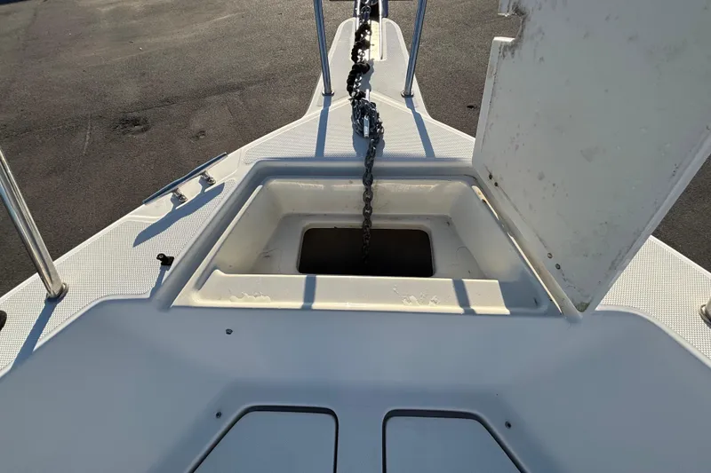 Slide: The Image of 2004 Hydra-Sports Lightning 230 CC anchor compartment with chain on deck. - 41