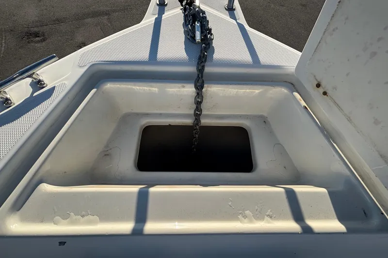 Slide: The Image of 2004 Hydra-Sports Lightning 230 CC anchor locker with chain, open on deck. - 42