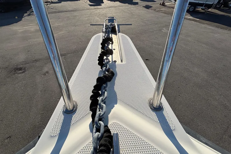 Slide: The Image of Bow of 2004 Hydra-Sports Lightning 230 CC with anchor chain and metal railings. - 46