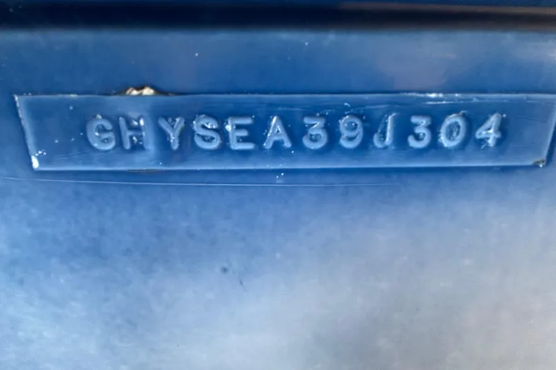 Slide: The Image of 2004 Hydra-Sports Lightning 230 CC hull identification number on blue surface. - 67