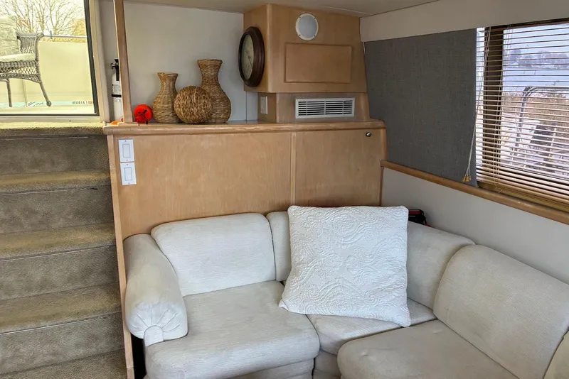 Slide: The Image of Interior of 1994 Carver 370 Aft Cabin Motor Yacht with cozy seating and decor. - 11