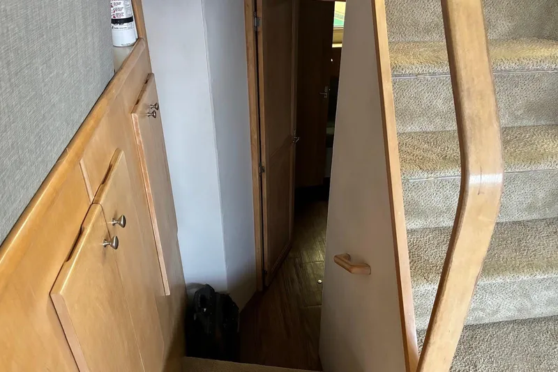 Slide: The Image of Interior stairs of 1994 Carver 370 Aft Cabin Motor Yacht, featuring wooden cabinetry. - 15