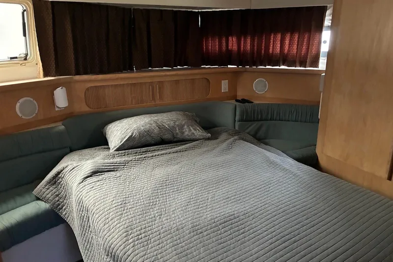 Slide: The Image of Cozy bedroom in 1994 Carver 370 Aft Cabin Motor Yacht with quilted bedding. - 16