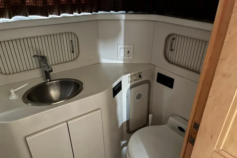 Slide: The Image of 1994 Carver 370 Aft Cabin Motor Yacht bathroom with sink and toilet. - 18