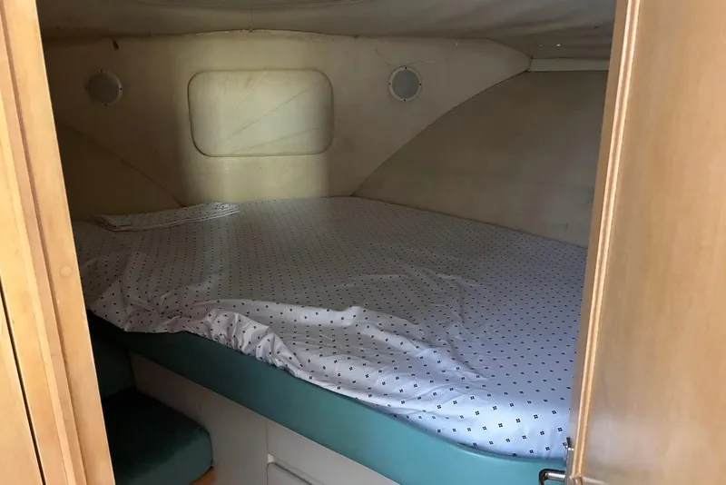 Slide: The Image of Cozy cabin interior of 1994 Carver 370 Aft Cabin Motor Yacht with bed and portholes. - 20