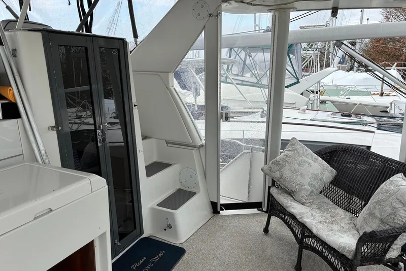 Slide: The Image of 1994 Carver 370 Aft Cabin Motor Yacht interior with wicker seating and glass doors. - 6