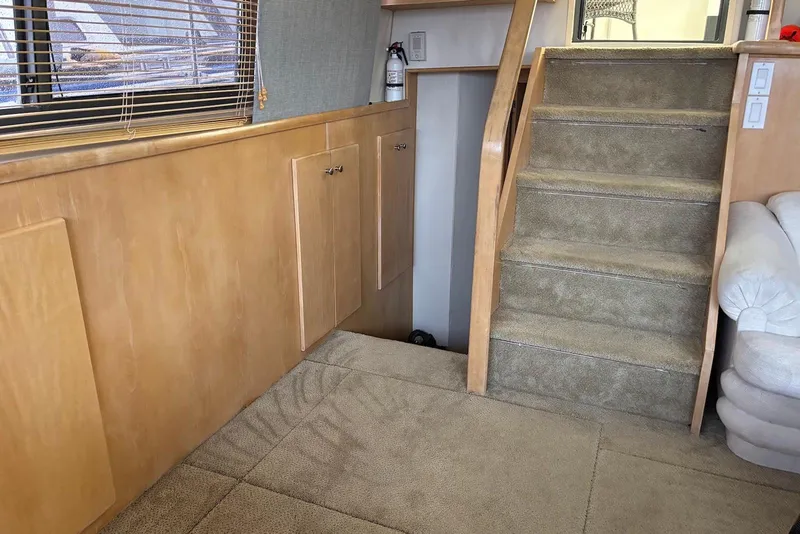 Slide: The Image of Interior of 1994 Carver 370 Aft Cabin Motor Yacht with carpeted stairs and wooden paneling. - 9