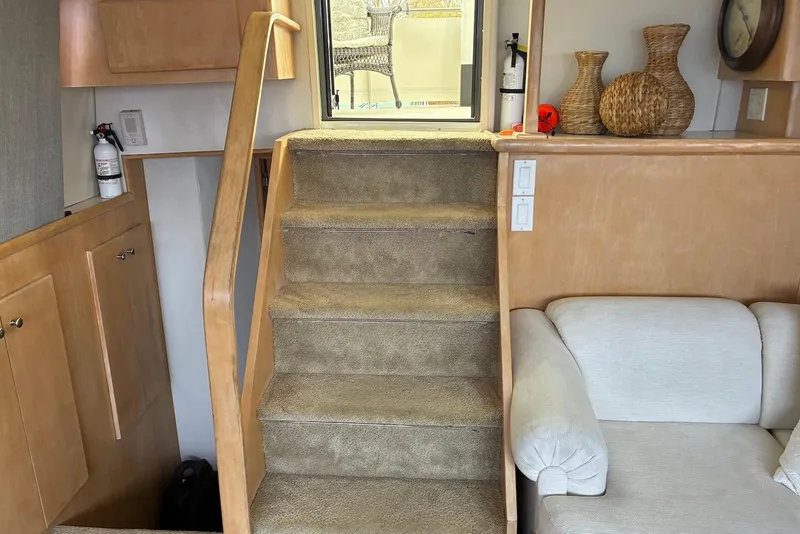 Slide: The Image of Interior of 1994 Carver 370 Aft Cabin Motor Yacht with carpeted stairs and cozy seating area. - 10