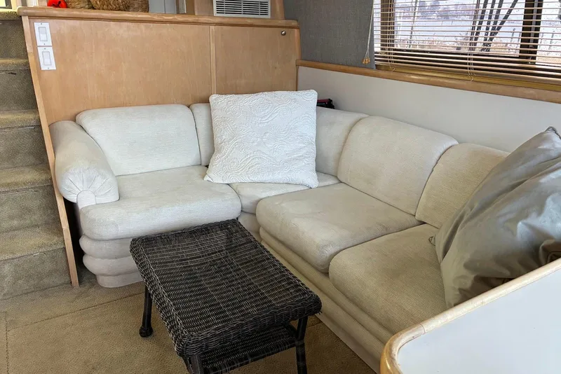 Slide: The Image of Interior of 1994 Carver 370 Aft Cabin Motor Yacht with beige sofa and wicker table. - 12