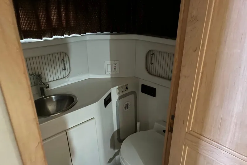 Slide: The Image of 1994 Carver 370 Aft Cabin Motor Yacht bathroom with sink and toilet. - 17