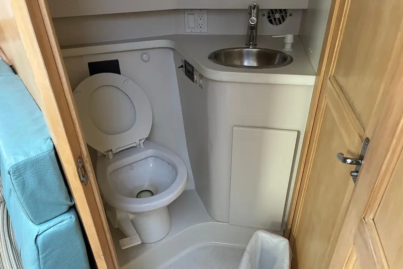 Slide: The Image of 1994 Carver 370 Aft Cabin Motor Yacht bathroom with toilet and sink. - 21