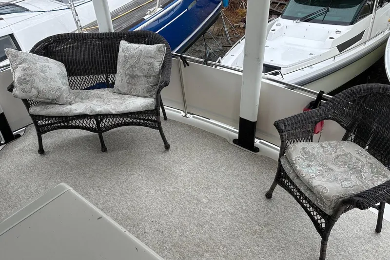 Slide: The Image of 1994 Carver 370 Aft Cabin Motor Yacht deck with wicker seating and cushions. - 5
