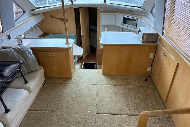 Slide: The Image of Interior of 1994 Carver 370 Aft Cabin Motor Yacht with cozy seating and kitchenette. - 7
