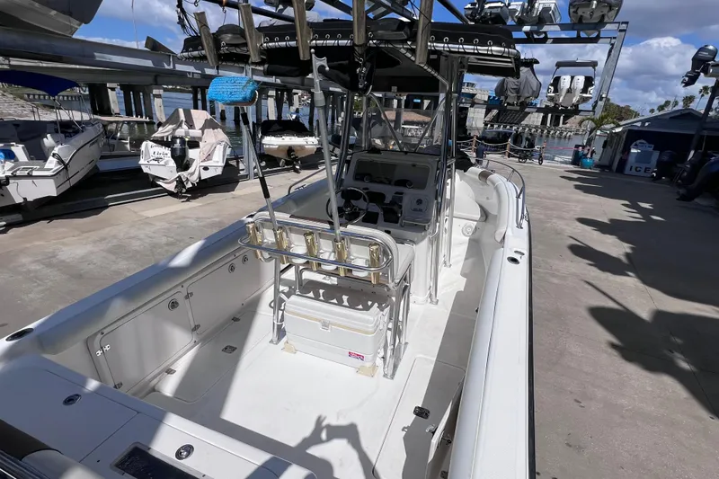 Slide: The Image of 2003 Century 2600 Center Console boat docked at marina under clear skies. - 10
