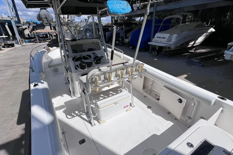 Slide: The Image of 2003 Century 2600 Center Console boat with spacious deck and fishing rod holders. - 11
