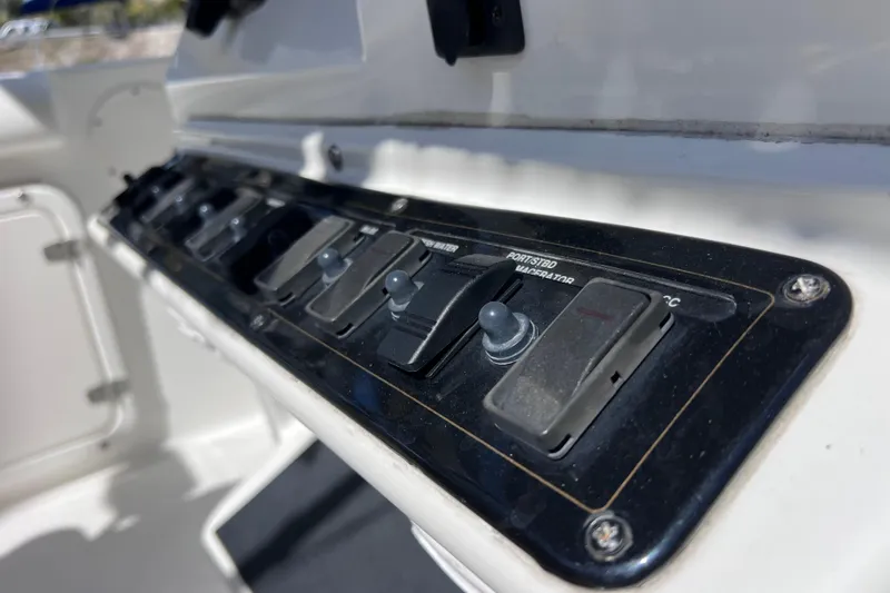 Slide: The Image of Control panel of a 2003 Century 2600 Center Console boat with switches. - 18