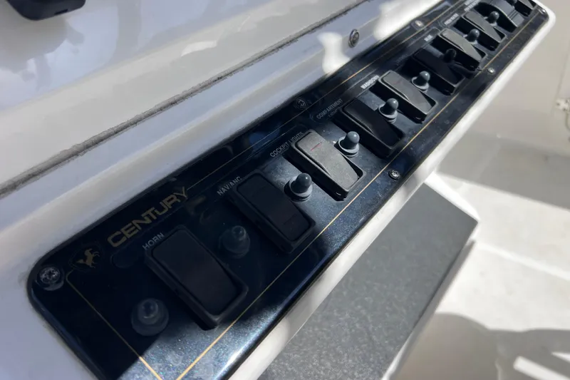 Slide: The Image of Control panel of a 2003 Century 2600 Center Console boat with labeled switches. - 19