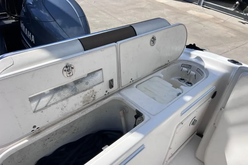 Slide: The Image of 2003 Century 2600 Center Console boat with open storage compartments and Yamaha engine. - 22