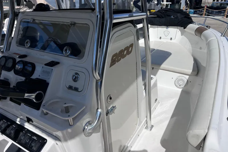Slide: The Image of 2003 Century 2600 Center Console boat interior with steering controls and seating area. - 26