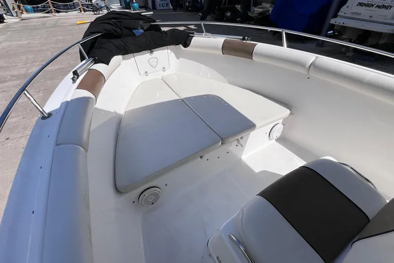 Slide: The Image of 2003 Century 2600 Center Console boat interior with cushioned seating and railing. - 28