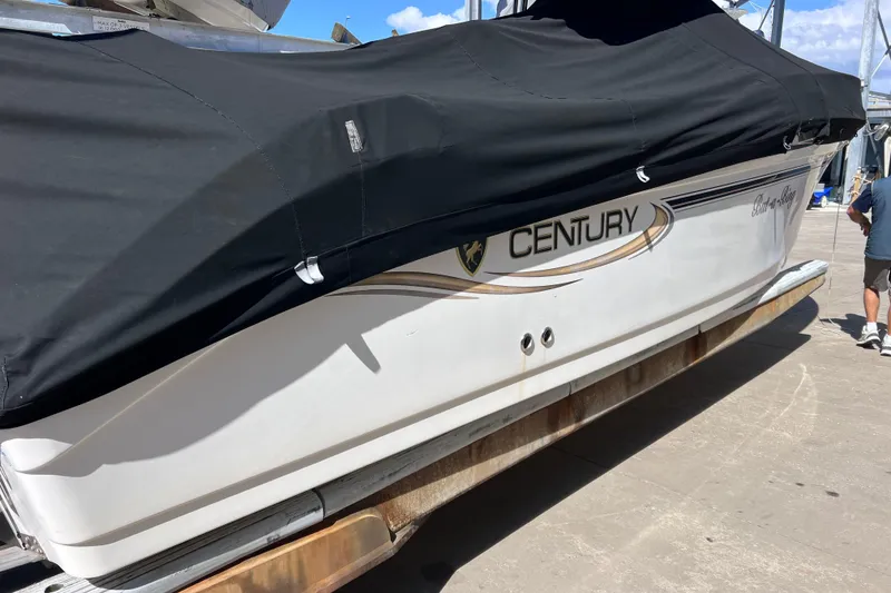 Slide: The Image of 2003 Century 2600 Center Console boat with black cover on a trailer. - 3