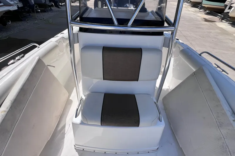 Slide: The Image of 2003 Century 2600 Center Console boat seating area with cushioned seats and metal frame. - 32