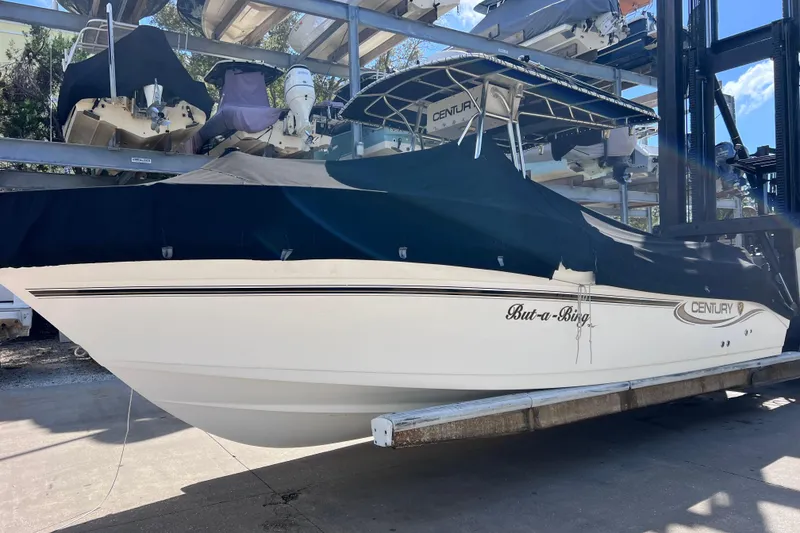 Slide: The Image of 2003 Century 2600 Center Console boat covered and stored on a rack. - 4