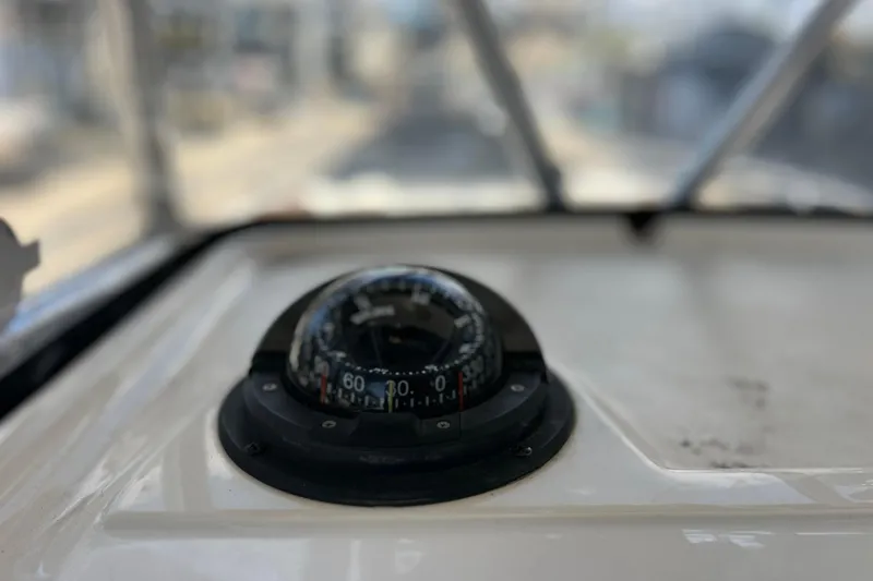 Slide: The Image of Compass on 2003 Century 2600 Center Console boat dashboard, with blurred background. - 41