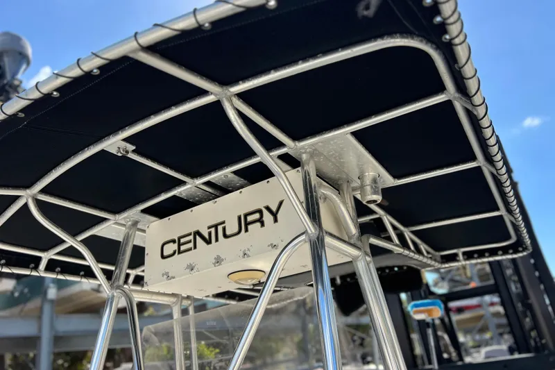 Slide: The Image of 2003 Century 2600 Center Console boat with T-top and clear blue sky background. - 44