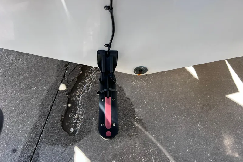 Slide: The Image of 2003 Century 2600 Center Console boat with transducer on concrete surface. - 49