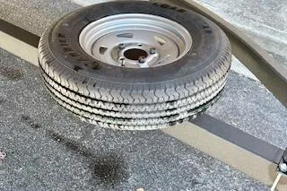 Slide: The Image of 2023 Sun Tracker Bass Buggy 16 XL Select trailer with spare tire mounted underneath. - 11