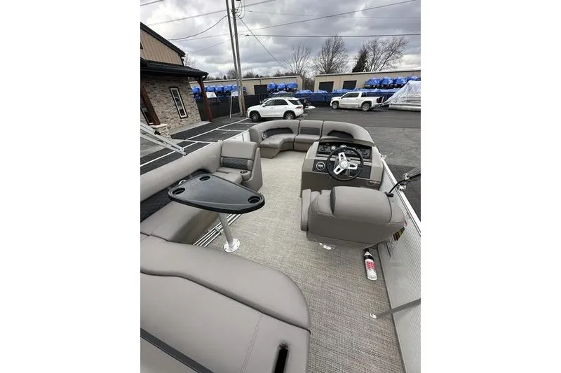 Slide: The Image of 2019 Bennington SX 22 SSBXP pontoon boat interior with gray seating and steering console. - 13