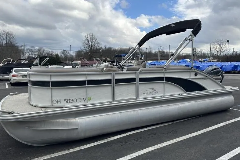 Slide: The Image of 2019 Bennington SX 22 SSBXP pontoon boat parked outdoors under cloudy sky. - 5