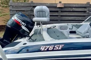 Slide: The Image of 2008 Stratos 476 Ski-N-Fish boat with Suzuki outboard motor, featuring comfortable seating. - 13