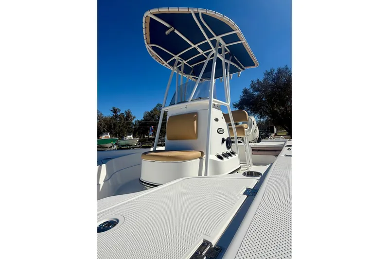 Slide: The Image of 2018 Epic 24 Bay Center Console boat with T-top, docked under clear blue sky. - 11