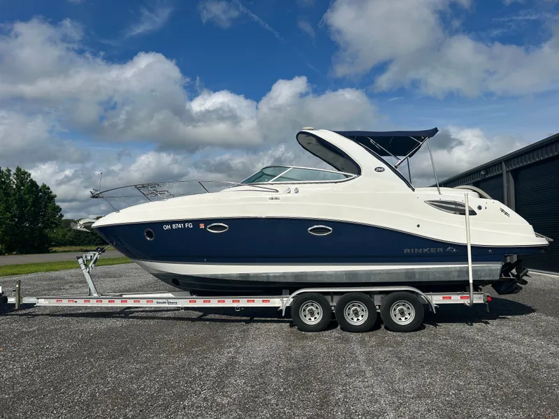 Slide: The Image of 2013 Rinker 290 Express Cruiser on trailer, blue sky. - 0