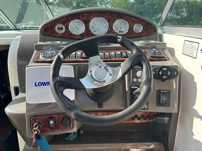 Slide: The Image of 2013 Rinker 290 Express Cruiser helm with instruments. - 29