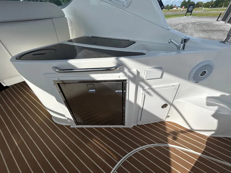 Slide: The Image of Interior of 2013 Rinker 290 Express Cruiser with fridge and sink. - 32