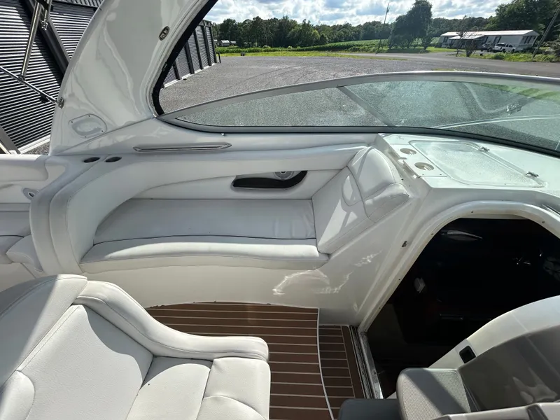 Slide: The Image of Interior of a 2013 Rinker 290 Express Cruiser with white seating. - 36