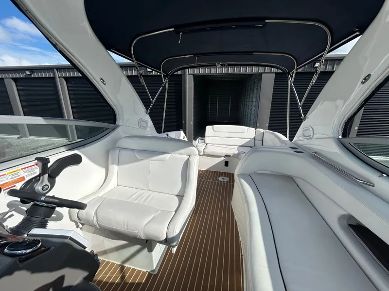 Slide: The Image of Interior of 2013 Rinker 290 Express Cruiser with white seating. - 37