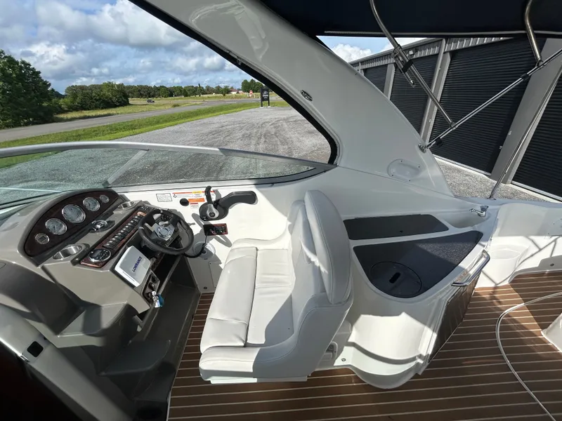 Slide: The Image of Interior of a 2013 Rinker 290 Express Cruiser with helm station. - 40