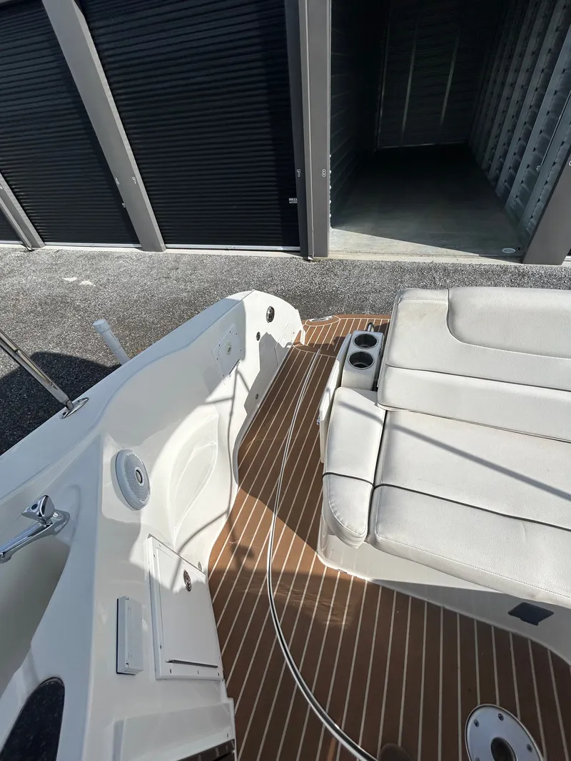 Slide: The Image of Interior of a 2013 Rinker 290 Express Cruiser with seating area. - 42